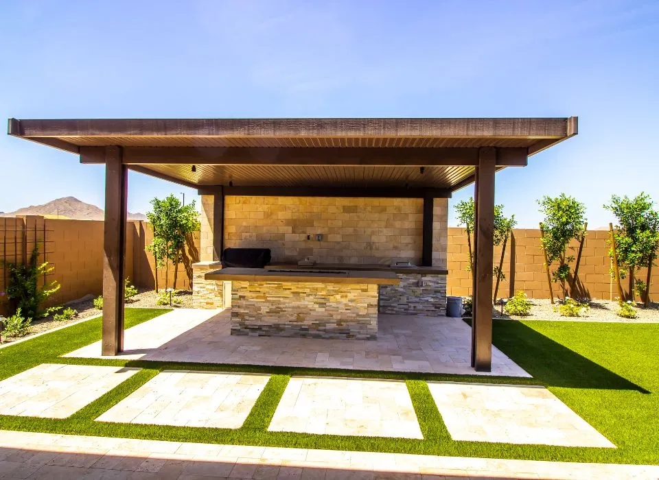 Luxury BBQ island with integrated evening lighting and outdoor bar seating for entertainment in Los Angeles by Dream Patios LA.